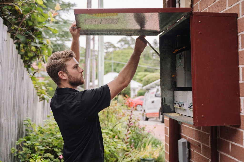 Electrician installing downlights in a Petersham home